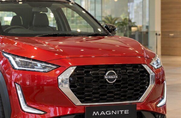 Red Nissan Magnite in a YouWe Nissan showroom